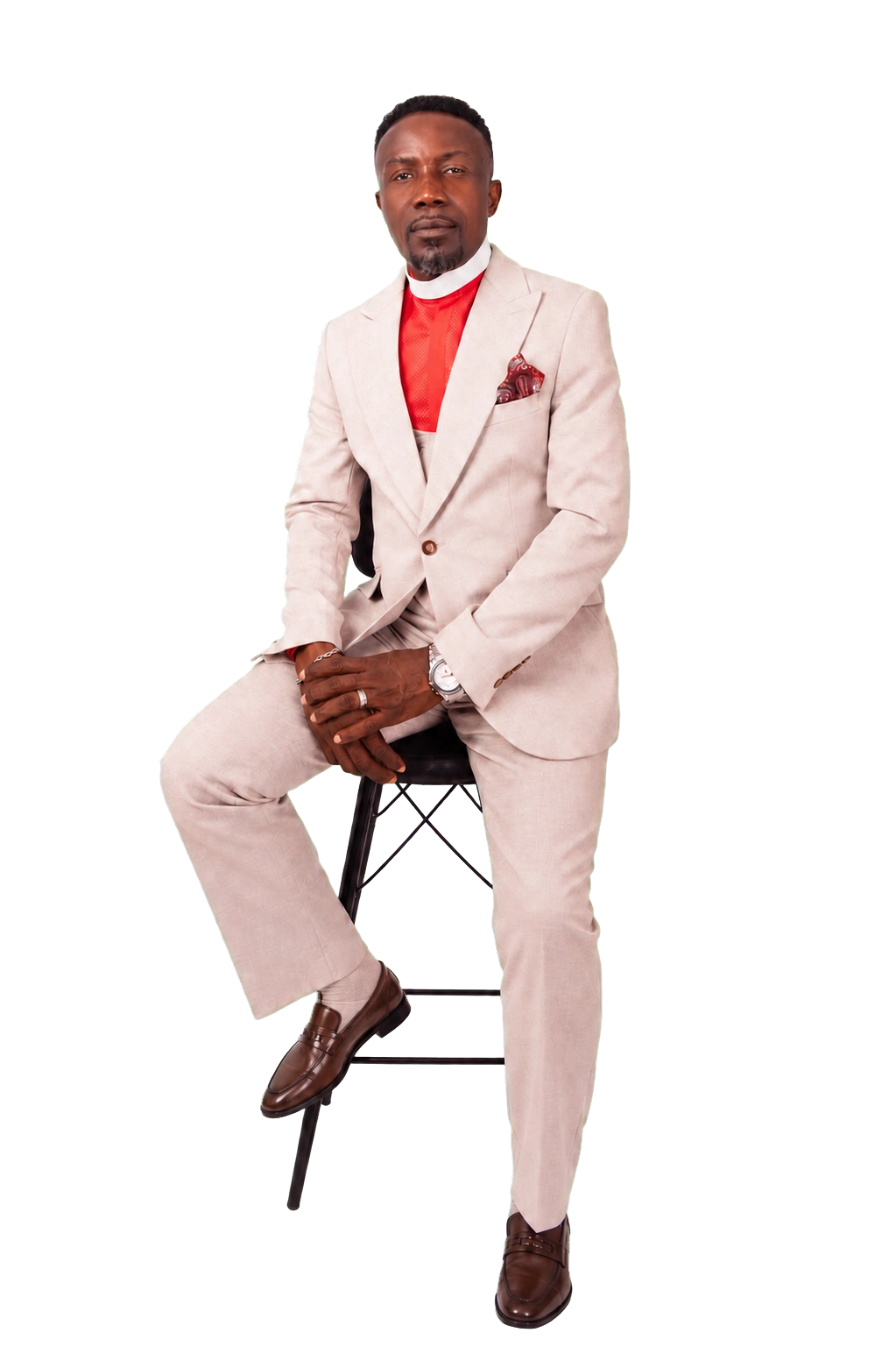 Apostle Isaac Kwabena Nana Adjei seated in a cream suit